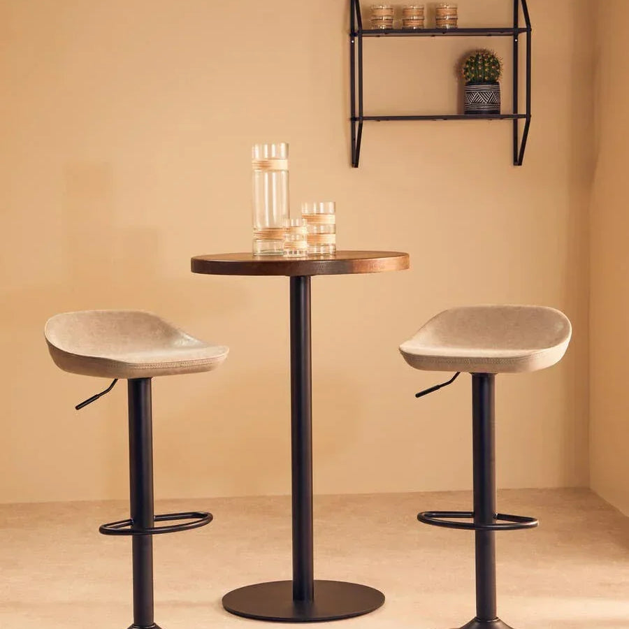 Modern bar table set with two beige swivel bar stools and black bases in minimalist room