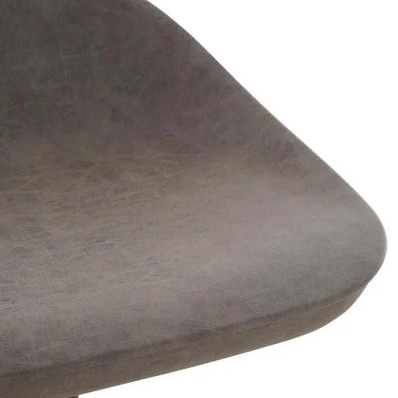 Closeup of grey faux leather dining chair seat with curved edge and black metal leg