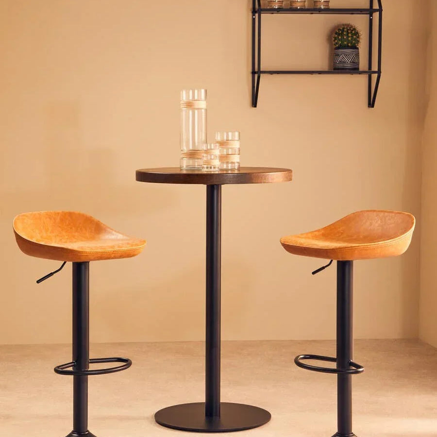 Leather bar stools with black metal bases and round table in modern dining setting