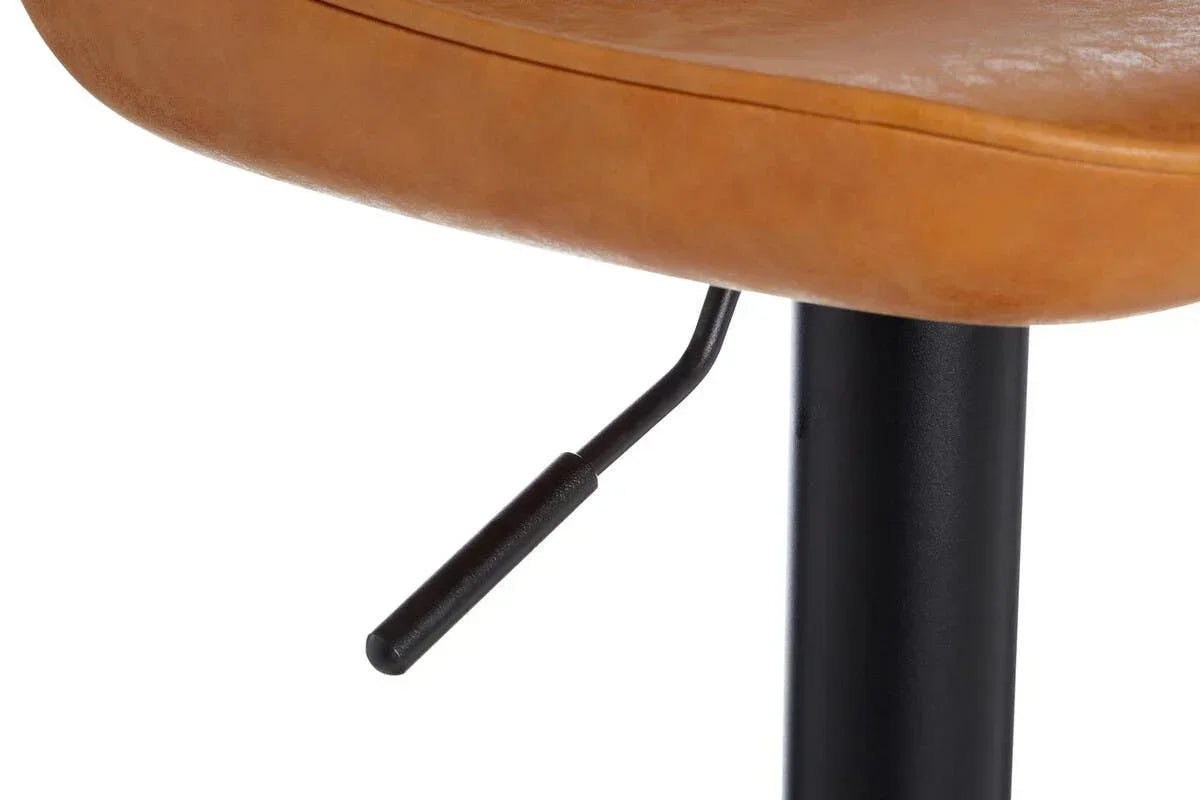 Tan faux leather bar stool seat with black metal gas lift lever close-up