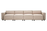 A long, armless modular sofa upholstered in natural fabric, featuring a sleek design with clean lines and a light beige color. The sofa is composed of multiple sections, each with a smooth surface and subtle stitching details, resting on small, round legs