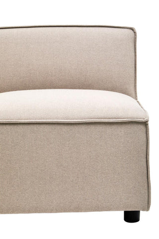 Armless modular sofa in natural fabric with a simple, modern design, featuring a cushioned seat and backrest, and resting on rounded black legs