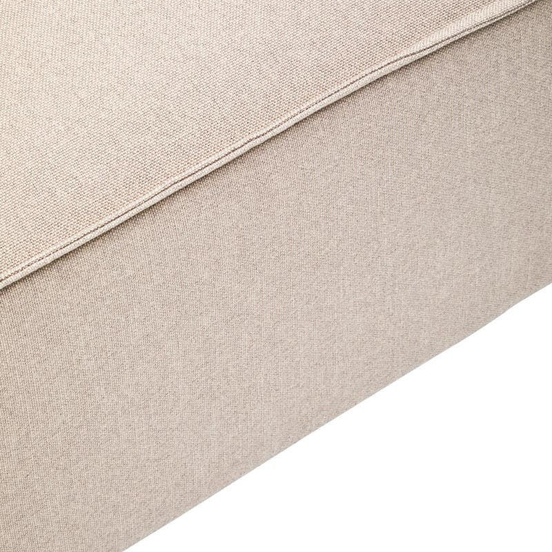 Natural fabric modular ottoman in a light beige color, featuring a smooth texture and clean lines, with a slightly rounded edge and a sturdy base