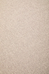 Close-up view of a textured, light beige fabric, showcasing a woven pattern suitable for a modular ottoman