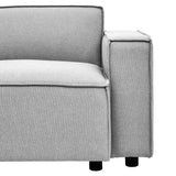 Right arm section of a modular sofa upholstered in grey fabric, featuring a clean, modern design with a square armrest and subtle piping detail. The sofa rests on short, cylindrical black legs