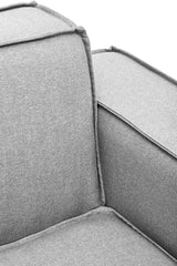 Close-up view of the Toulouse Grey Fabric Right Arm Modular Sofa, showcasing the soft grey upholstery, clean lines, and contrasting piping along the edges of the armrest and cushion