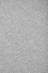 Soft grey fabric texture of a modular sofa, featuring a right arm design. The surface displays a subtle weave pattern, emphasizing the cozy and modern aesthetic