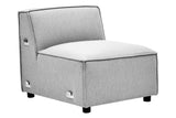 Armless modular sofa in a soft grey fabric with a minimalist design, featuring a plush seat cushion and a slightly angled backrest. The sofa has rounded edges and is supported by small black feet