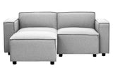 Grey fabric modular ottoman featuring a contemporary design with two cushioned sections and square armrests, supported by short black legs. The ottoman is versatile and can be arranged in various configurations