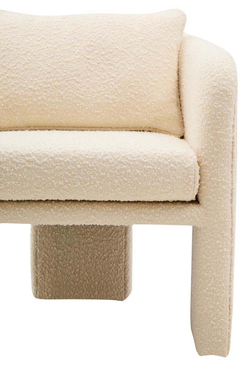 Cream boucle sofa close-up showing textured upholstery and modern armrest design