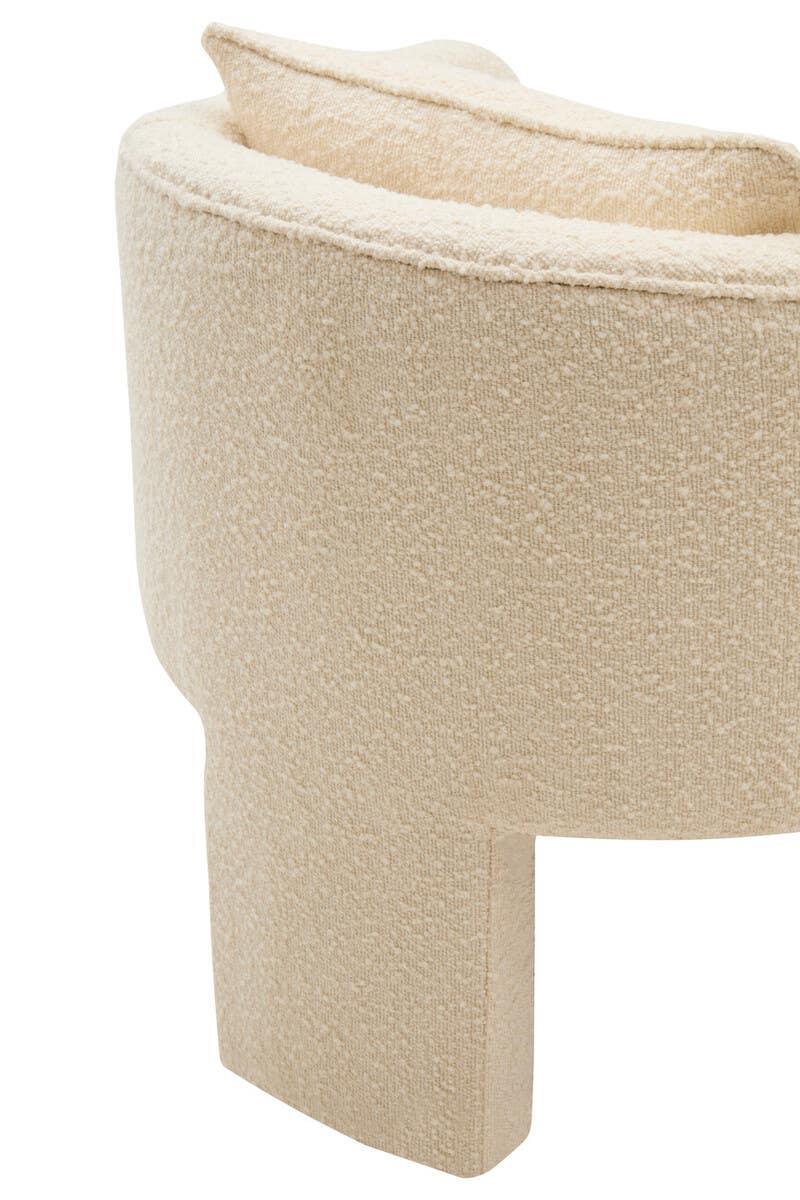 Close-up of cream boucle fabric armchair leg and curved backrest