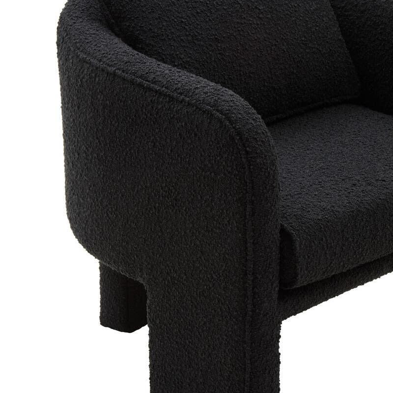 Modern black fabric armchair with curved armrest and textured upholstery