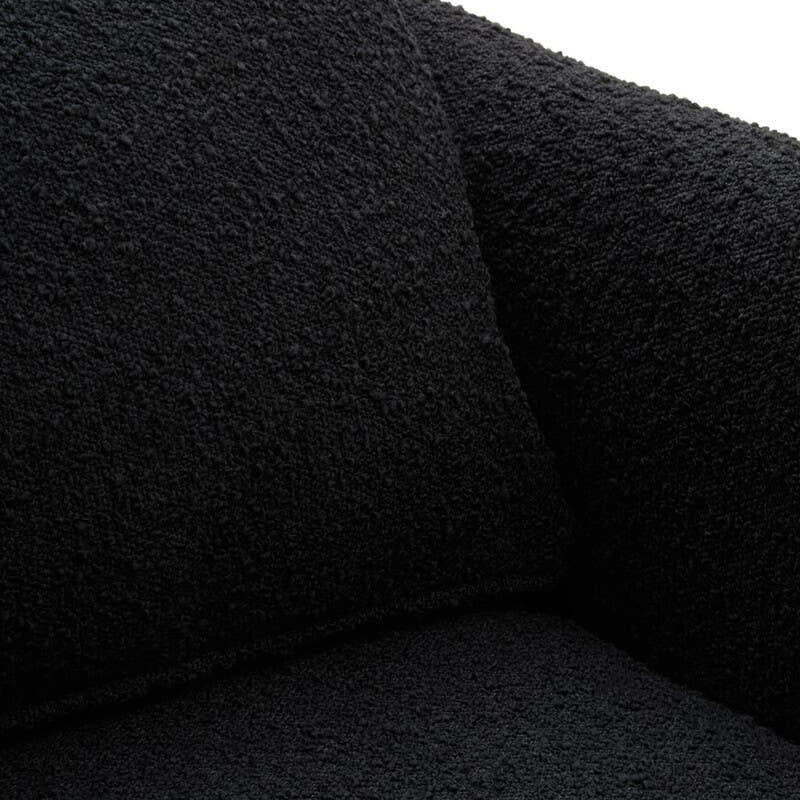 Black boucle sofa corner with textured fabric and matching cushion