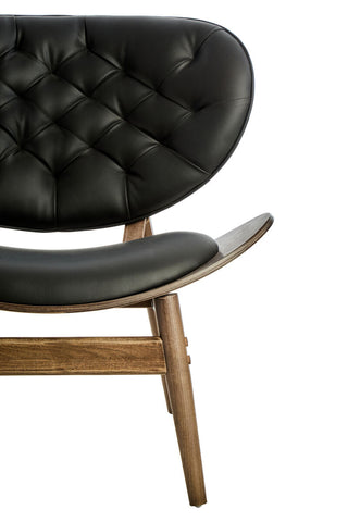 Black leather effect chair featuring a tufted backrest and a sleek, curved seat design.
