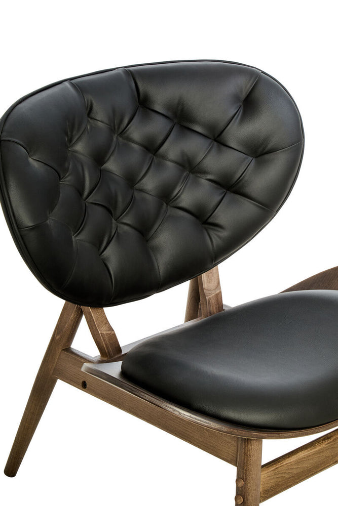 Black leather effect chair featuring a tufted backrest and a sleek, curved design.