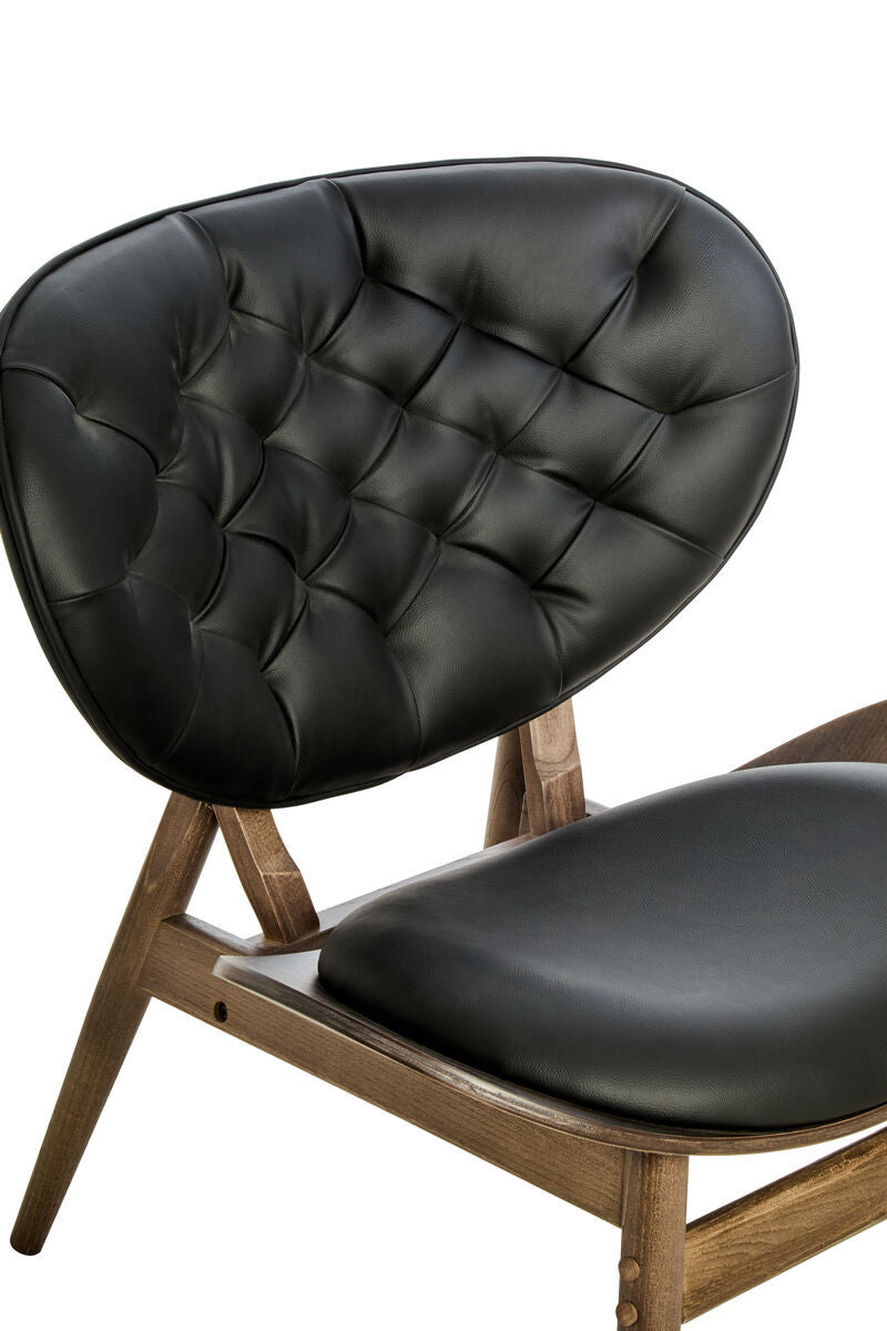 Black leather effect chair featuring a tufted backrest and a sleek, curved design.