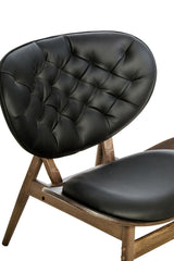Black leather effect chair featuring a tufted backrest and a sleek, curved design.