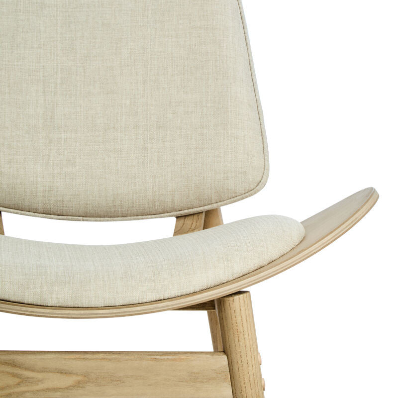 Beige fabric chair featuring a curved backrest and a comfortable seat, supported by a natural washed elm wood frame.