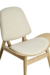 Beige fabric chair featuring a rounded backrest and a wide, cushioned seat, supported by natural washed elm wood legs.