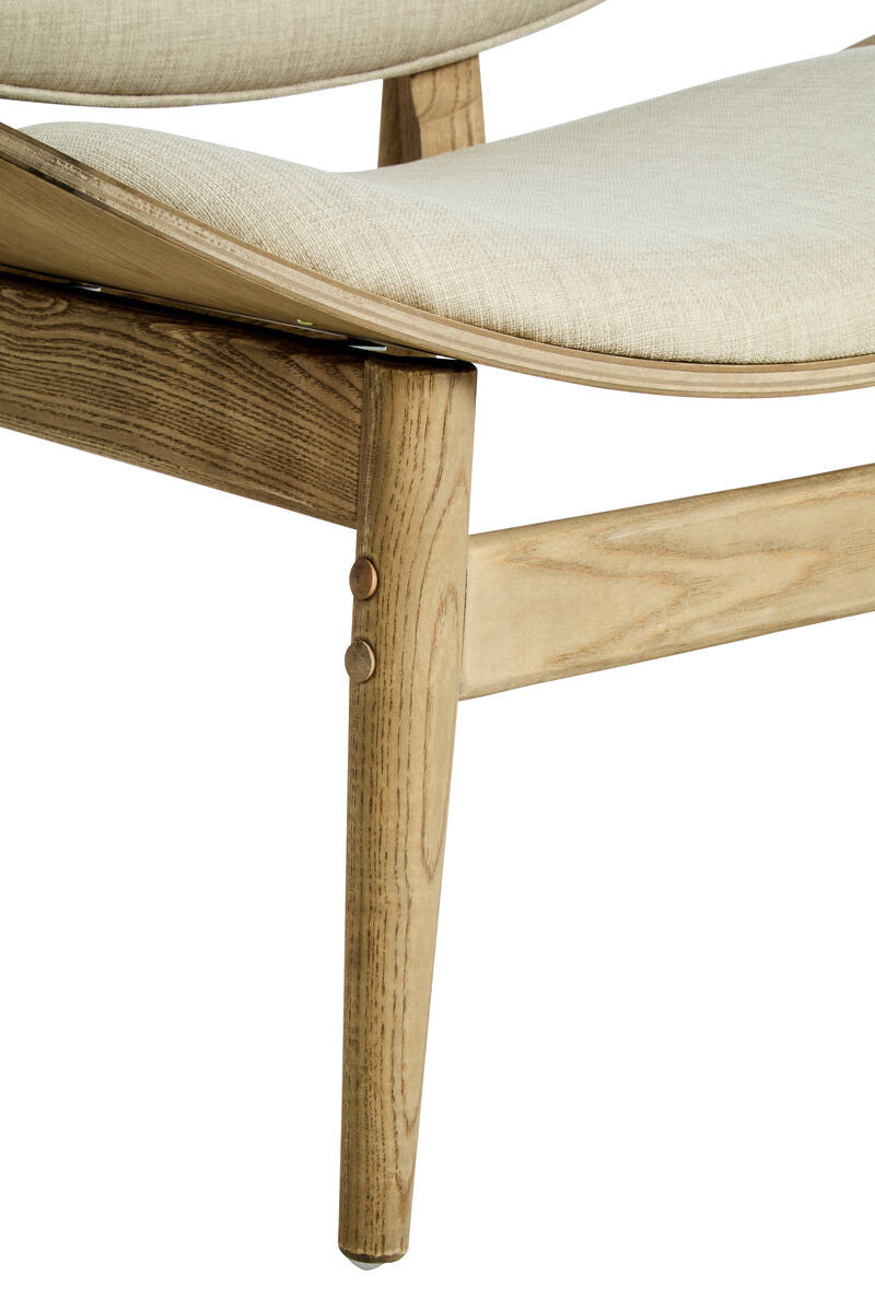 Beige fabric chair featuring a gently curved seat and backrest, supported by natural washed elm wood legs.