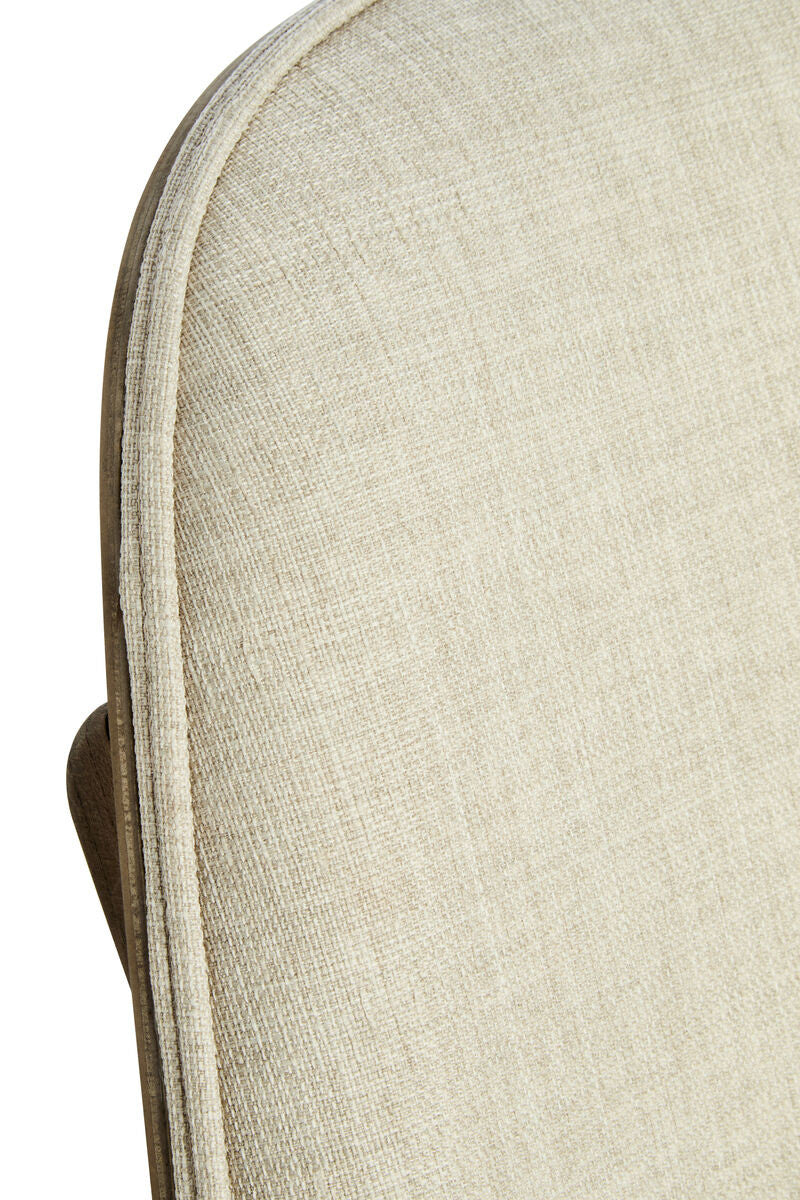 Beige fabric chair featuring a textured upholstery with a subtle weave pattern, complemented by a washed elm wood frame.