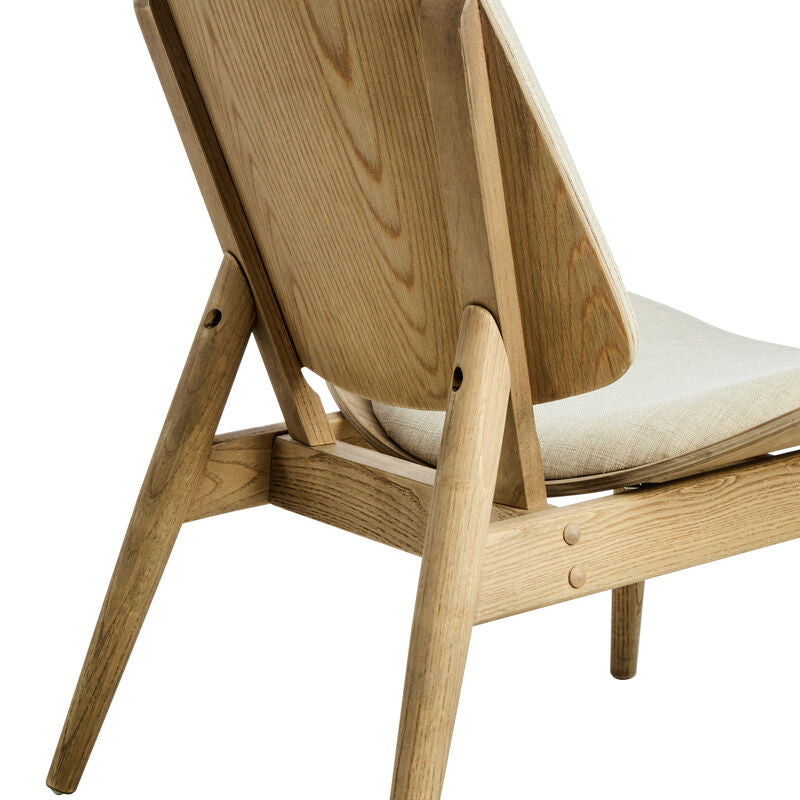 Beige fabric chair featuring a gently curved backrest and a seat cushion, supported by natural washed elm wood legs with a sleek, modern design.