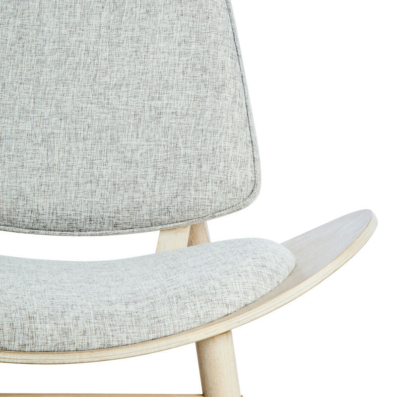 Grey fabric chair featuring a rounded backrest and a curved seat, supported by light washed elm wood legs.