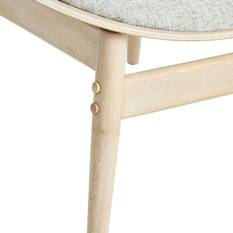 Grey fabric upholstered chair featuring a gently curved seat and washed elm wood legs.