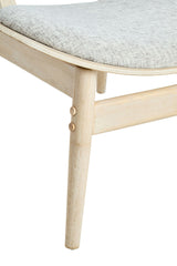 Grey fabric upholstered chair featuring a gently curved seat and washed elm wood legs.