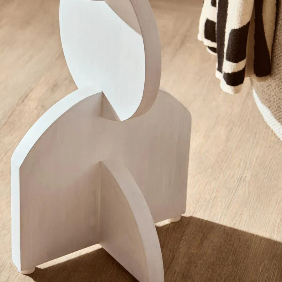 Close up of modern wooden furniture leg with geometric shapes on oak floor
