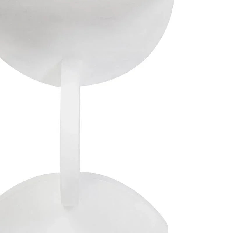 White round side table with sculptural base in close-up view