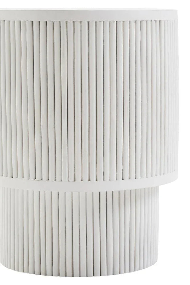 White side table with vertical fluted detailing and cylindrical shape