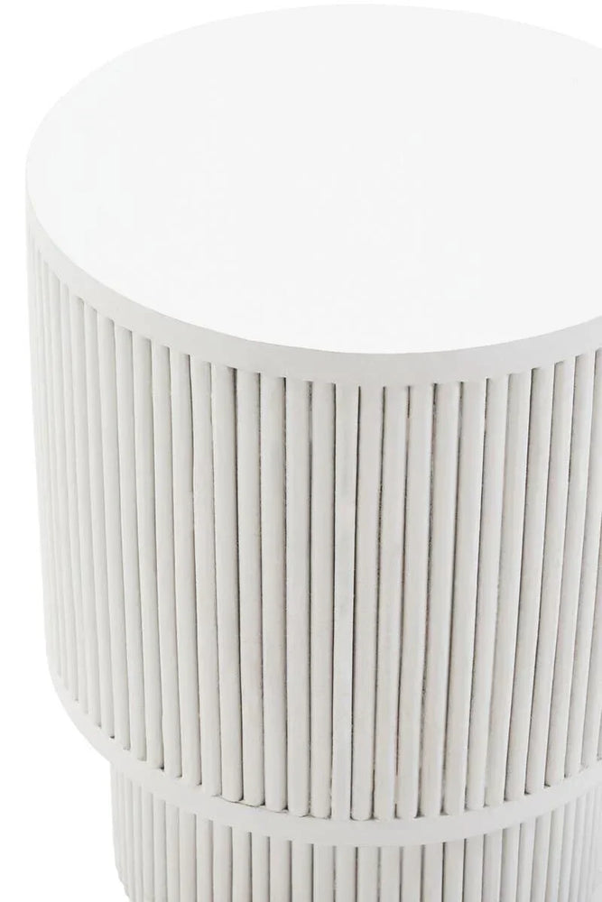 White round side table with fluted base and modern ribbed detail, close-up view