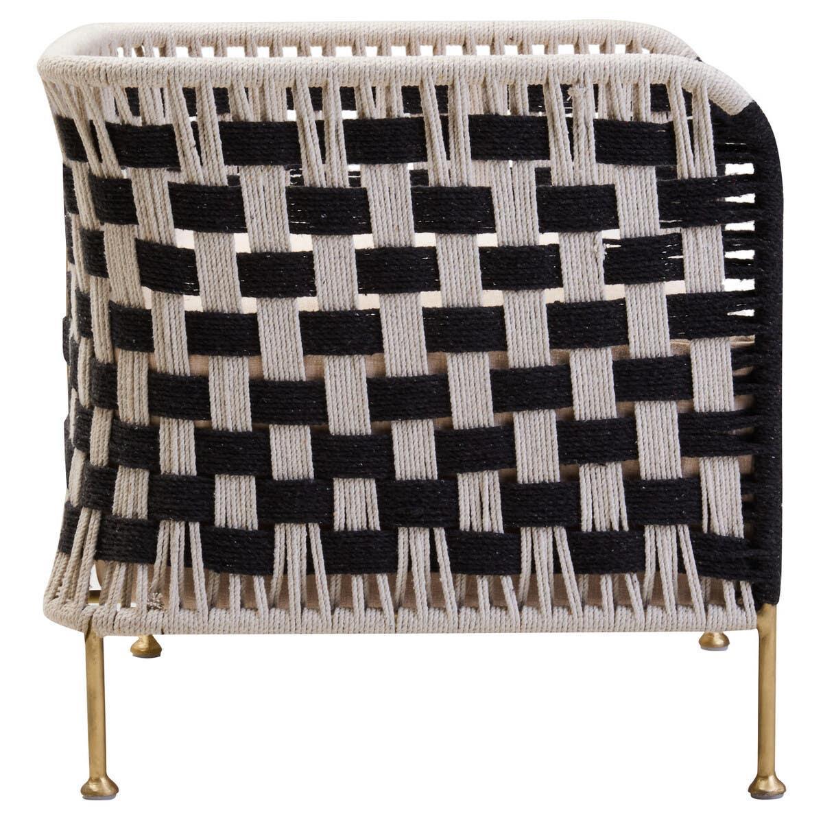 Black and cream woven accent chair with gold metal legs, rear view