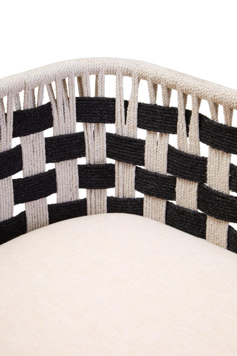 Closeup of woven rope chair backrest in black and natural with cream cushioned seat