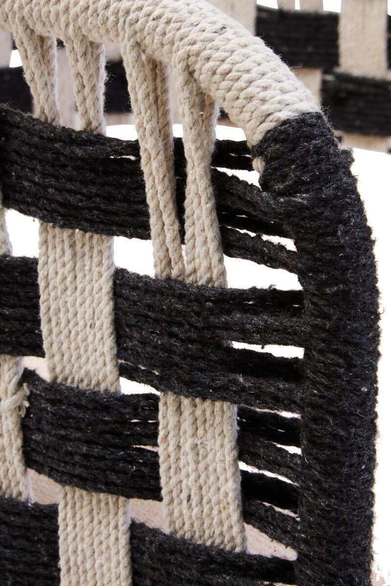 Close-up of woven rope dining chair back in black and beige
