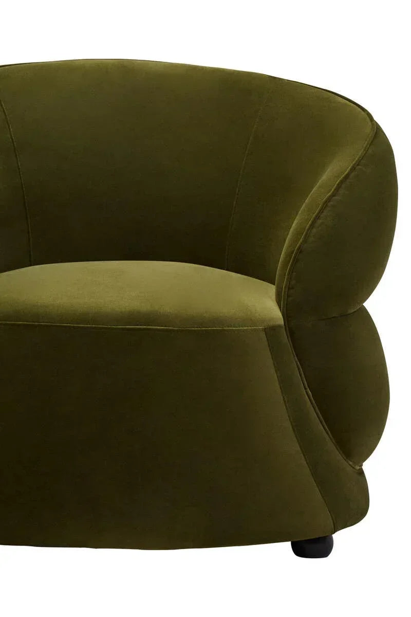 Olive green velvet accent chair with curved armrest and smooth cushioned seat, side angle