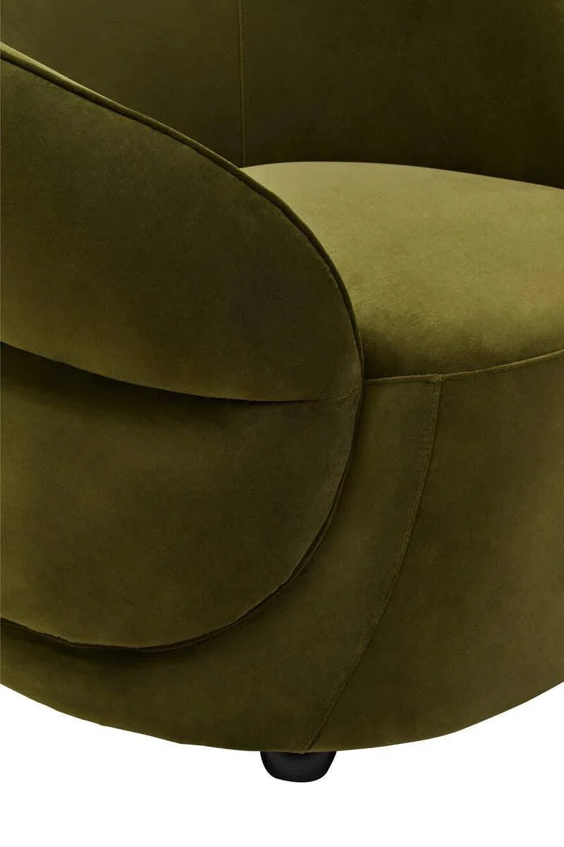 Close up of olive green velvet armchair seat and curved armrest