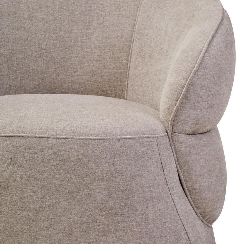 Curved beige fabric armchair with plush upholstery, close-up of seat and backrest