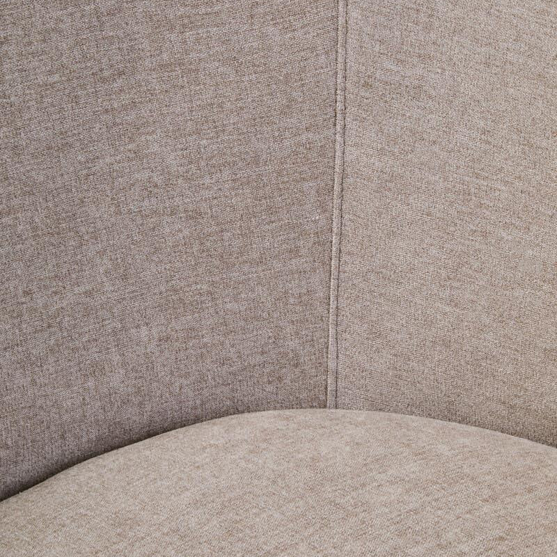 Closeup of beige fabric chair upholstery with visible stitching and curved seat