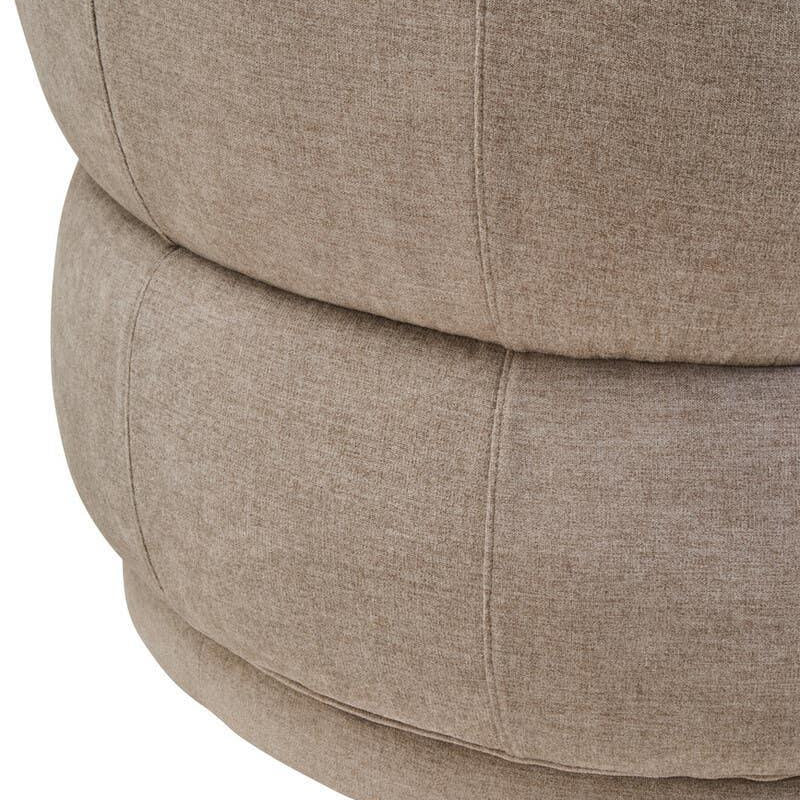 Closeup of beige fabric sofa base with visible stitching and rounded cushion design