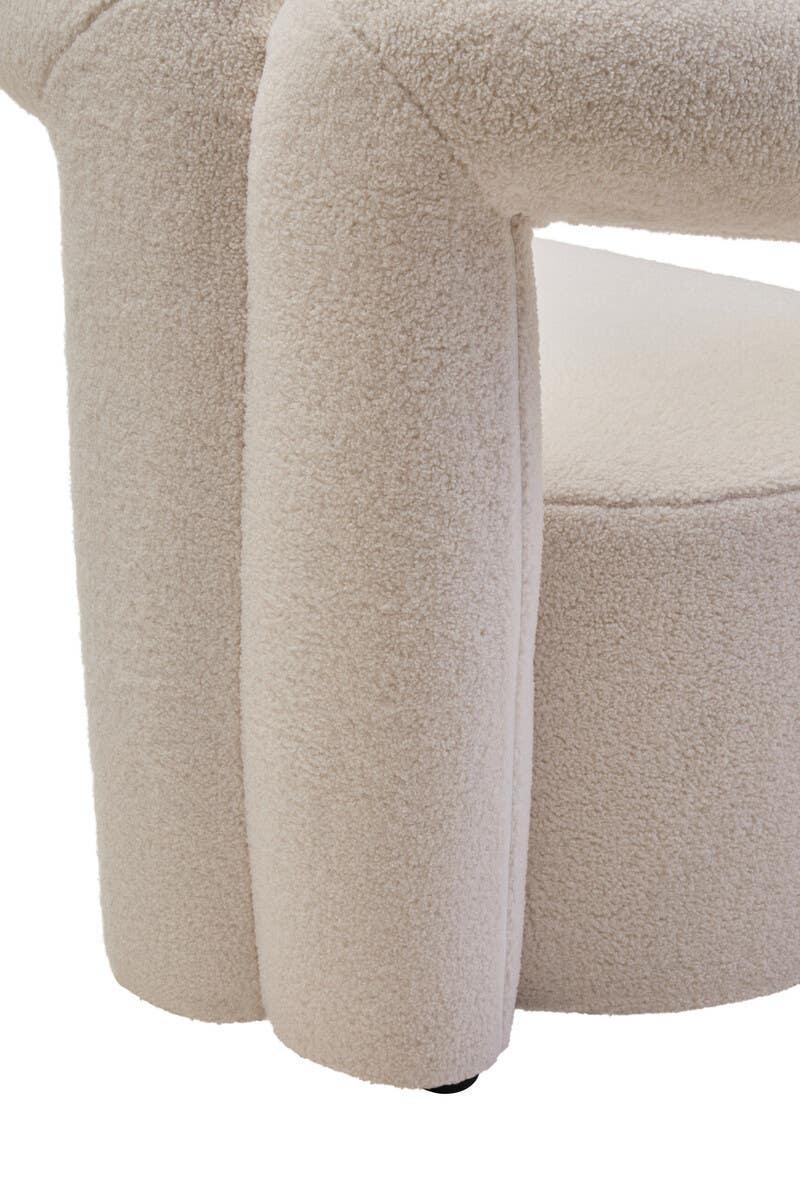Close-up of cream boucle accent chair leg and seat upholstery