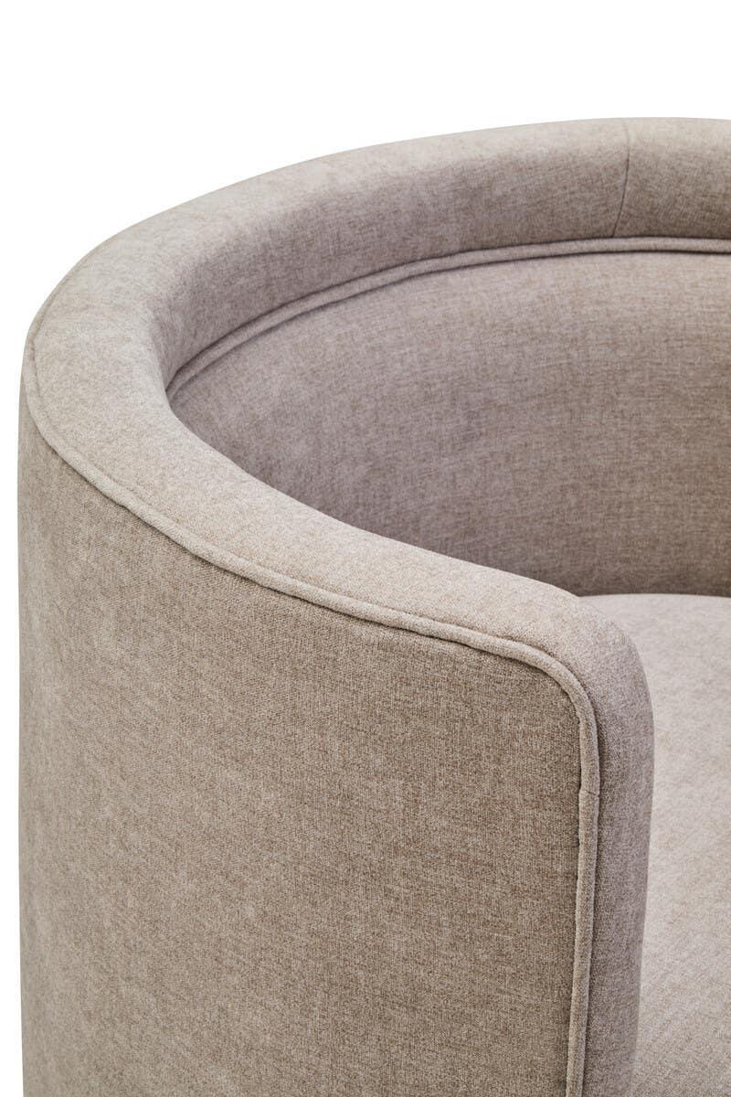 Closeup of modern beige fabric accent chair with curved backrest