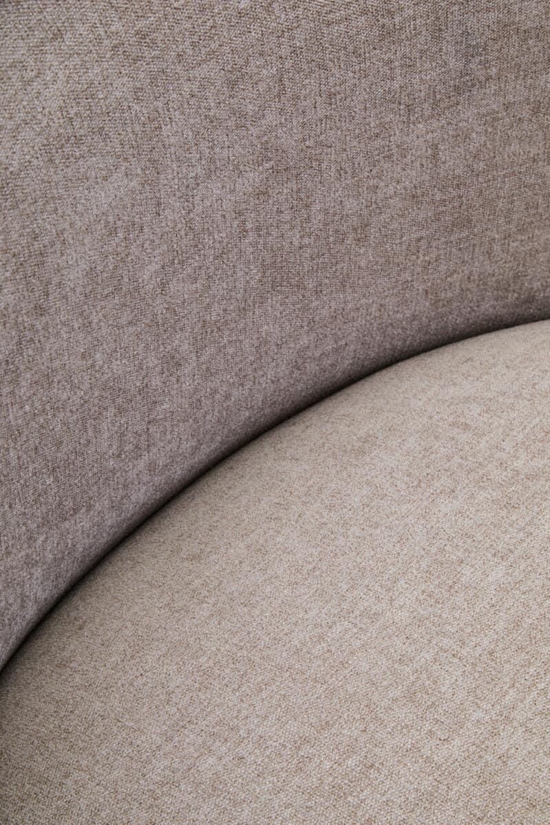 Close-up of beige fabric sofa seat and curved upholstered backrest