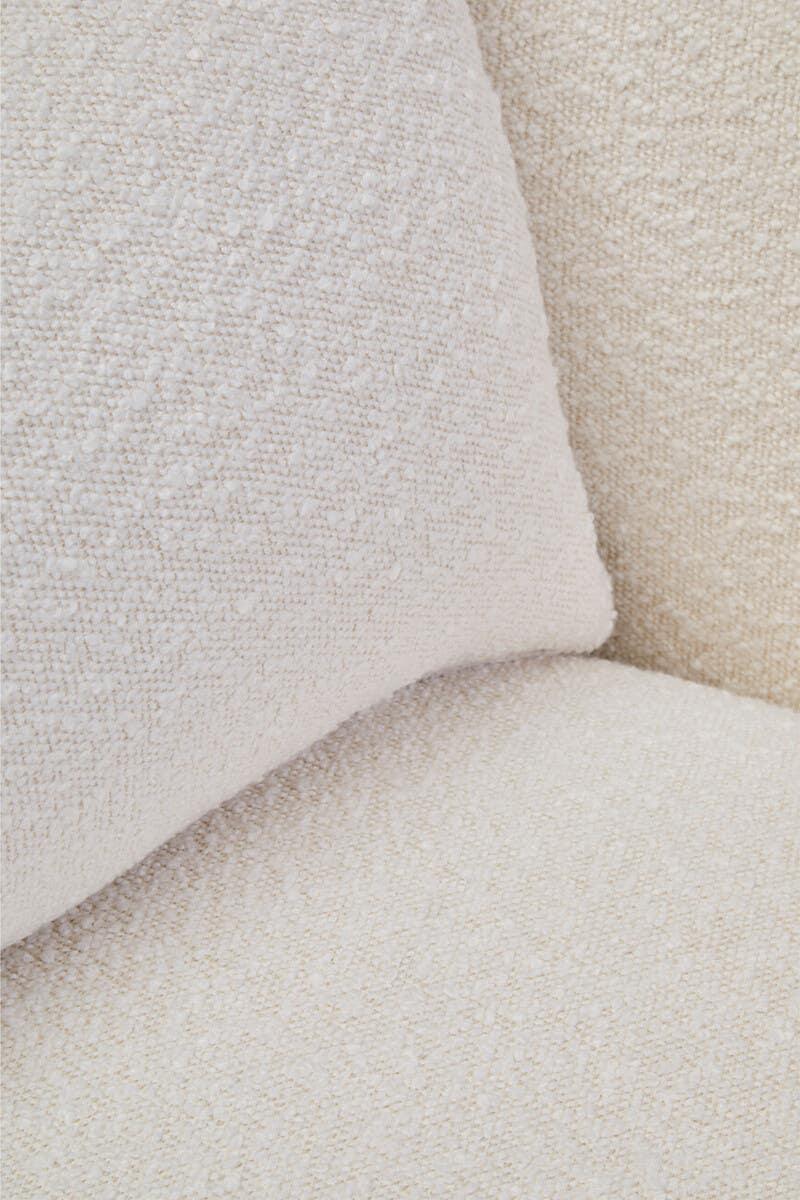 Close-up of cream fabric sofa cushion with textured upholstery