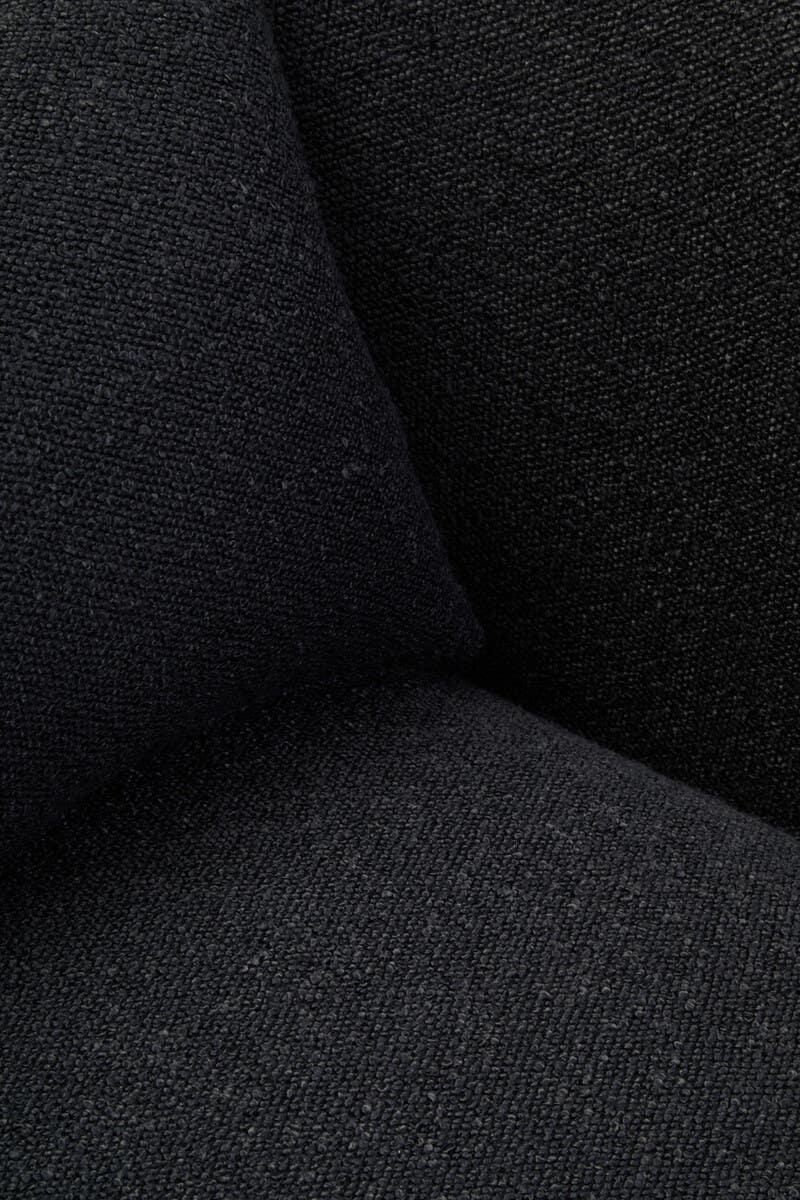 Close-up of black textured fabric sofa cushion corner