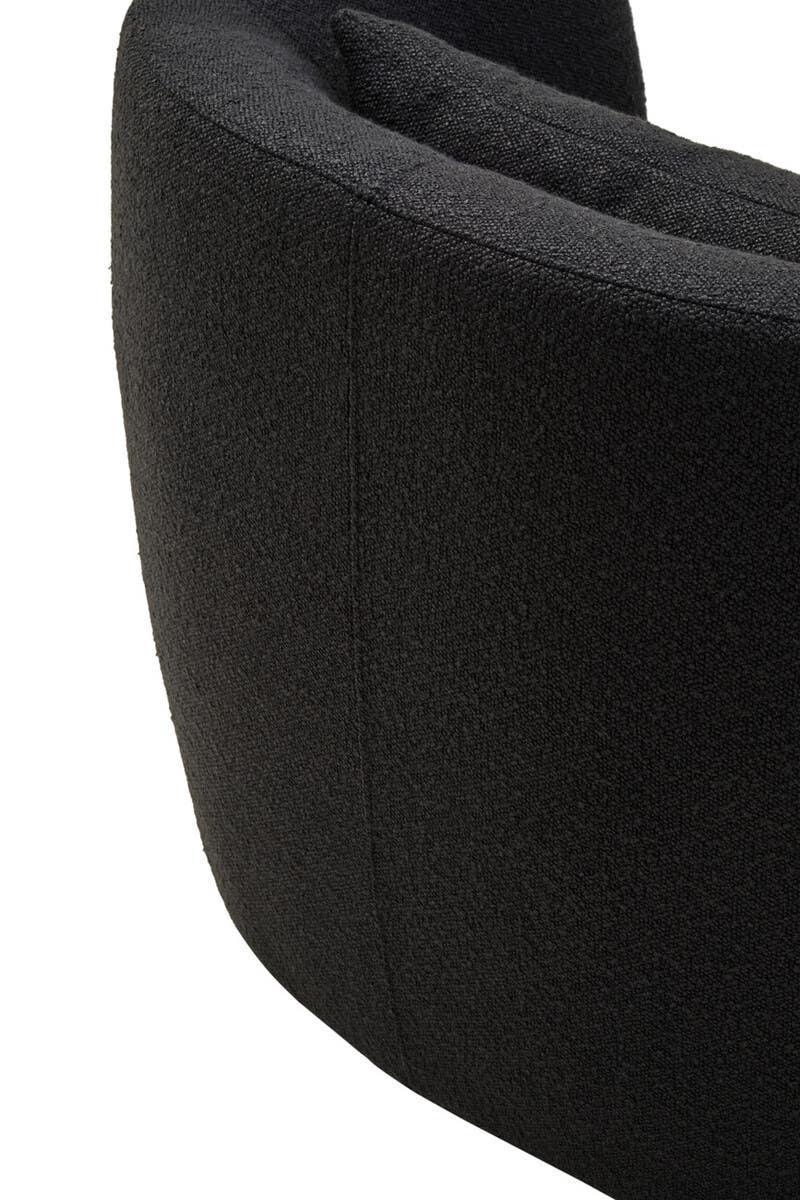Curved black fabric sofa backrest with visible seam and textured upholstery