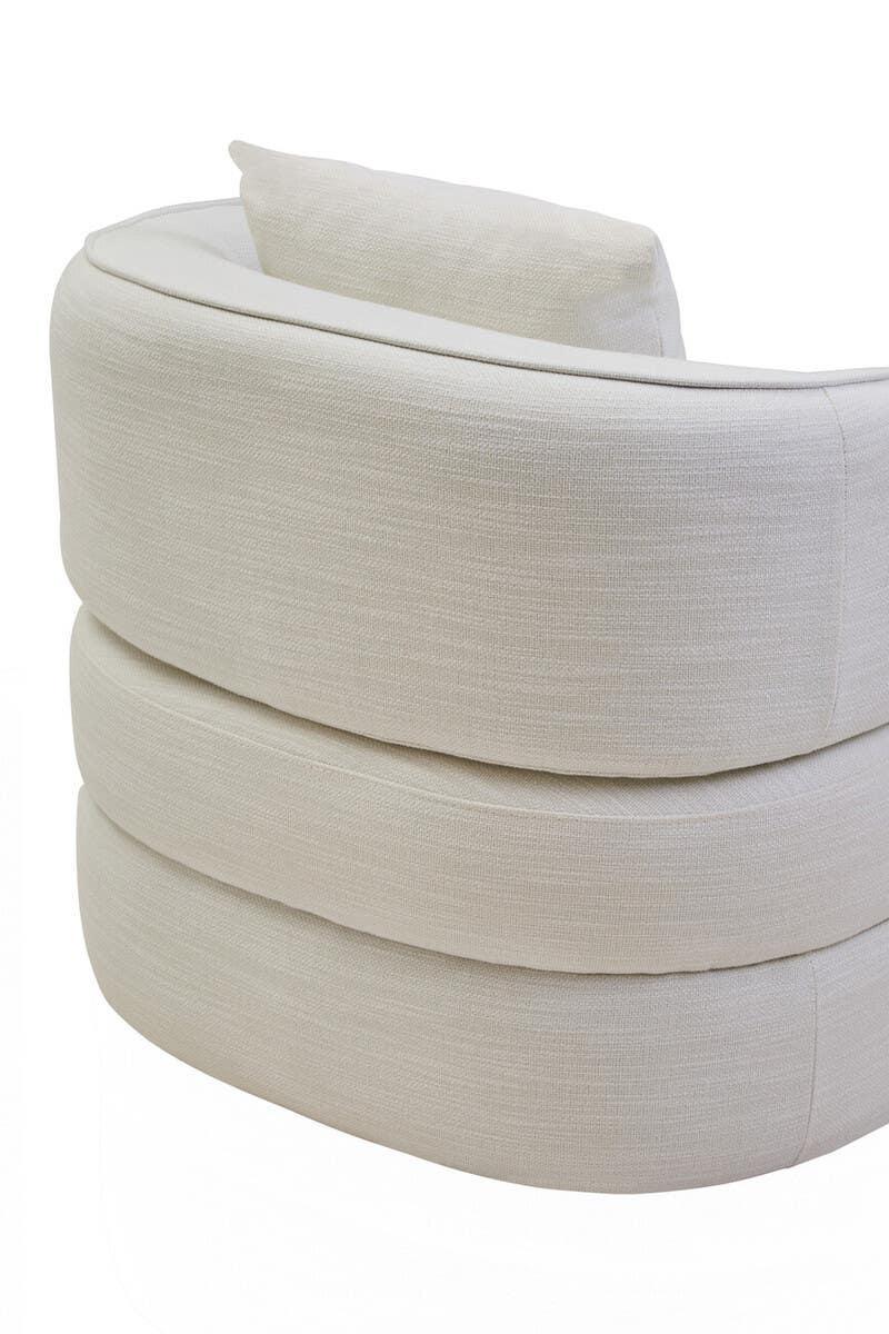 Curved cream fabric sofa with layered backrest detail, rear angle view