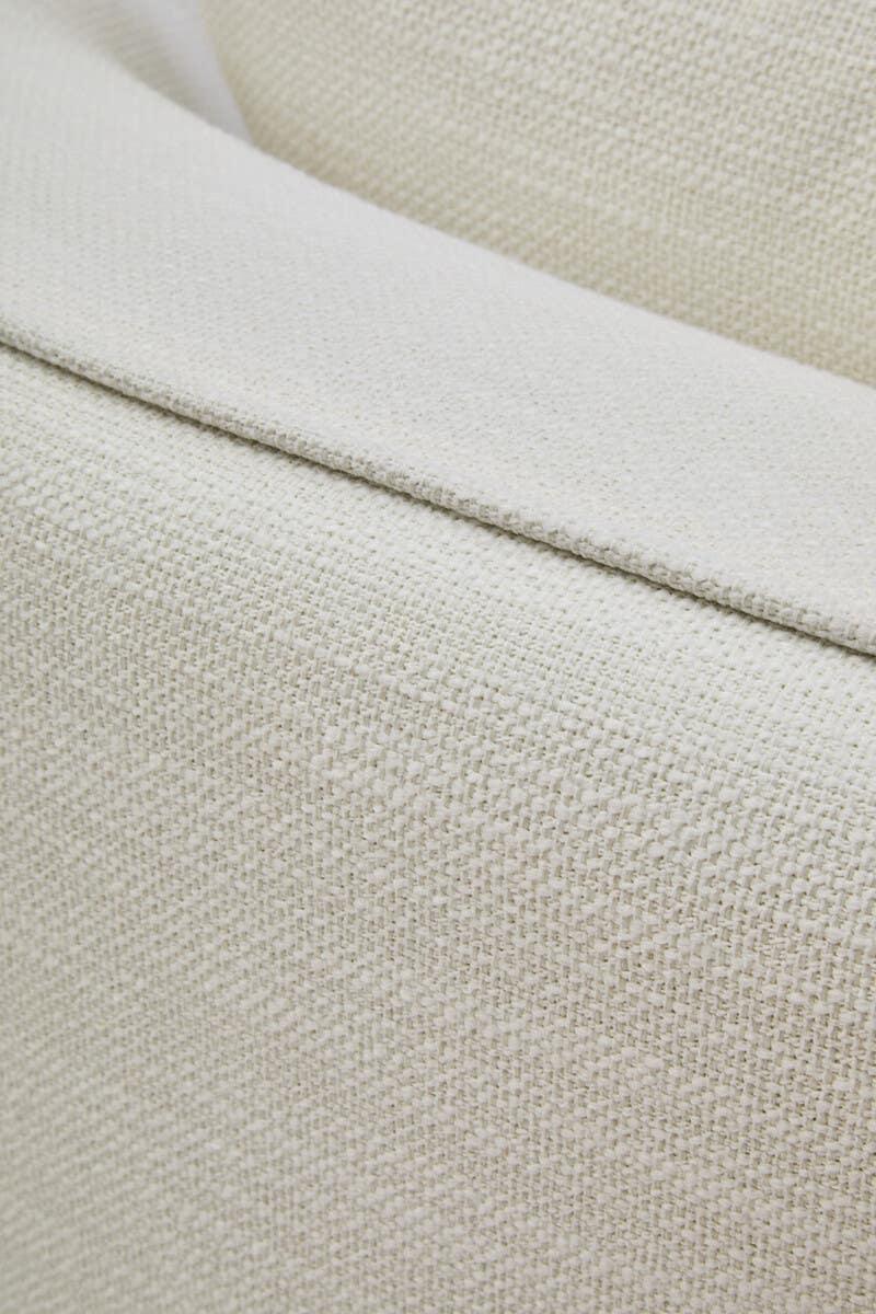 Close-up of cream textured sofa upholstery with visible seam detail