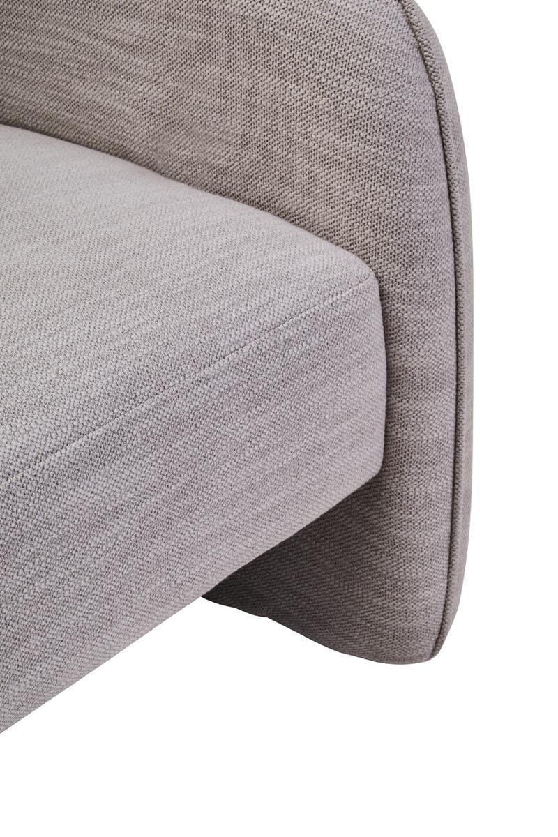 Close-up of light grey fabric sofa arm and seat cushion with textured upholstery